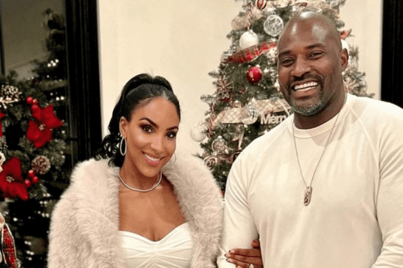 RHOBH newbie Annemarie Wiley and her husband former NFL star Marcellus Wiley pose for Christmas photo in fron of the tree